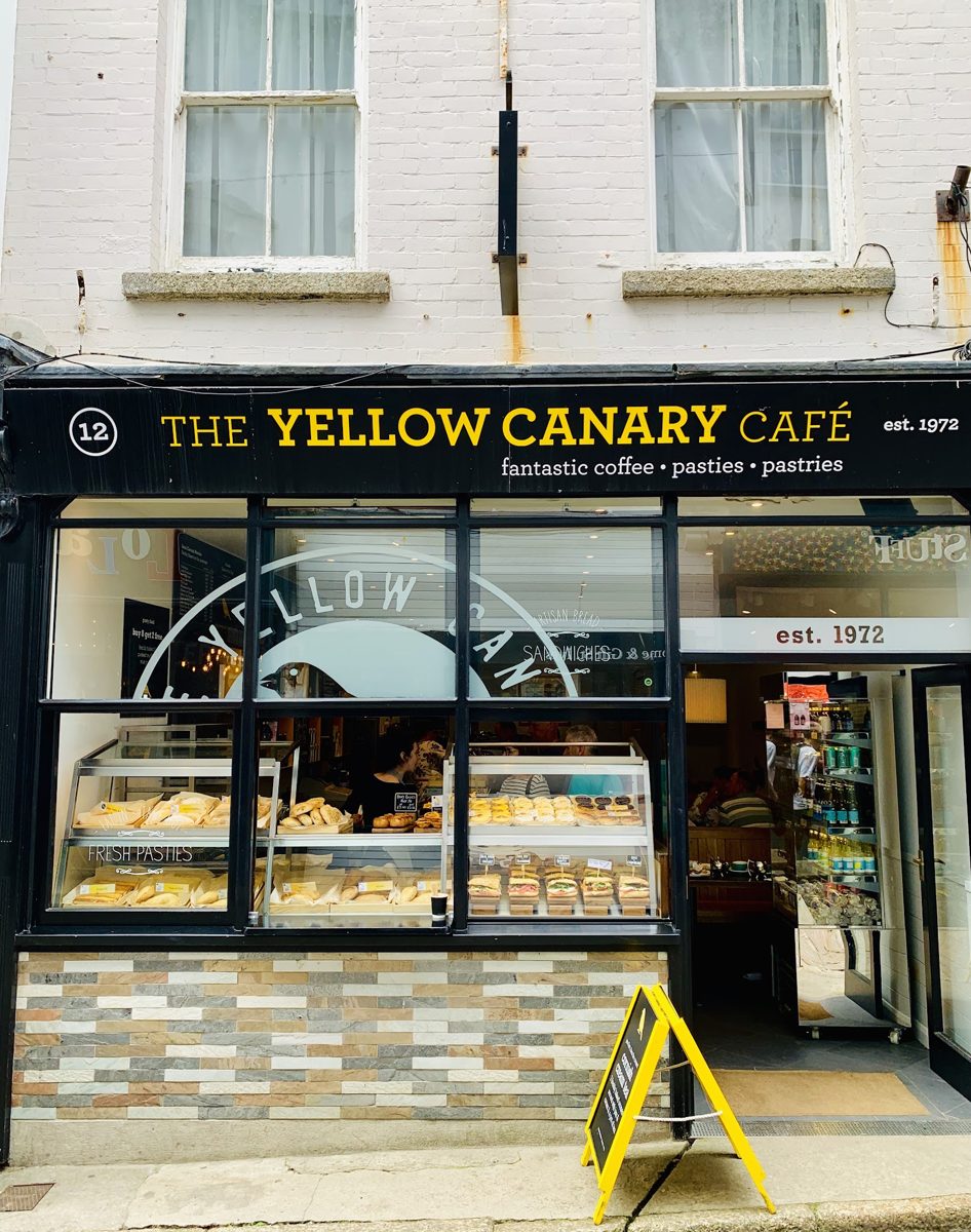 The Yellow Canary Café shopfront on Fore Street, with its yellow lettering